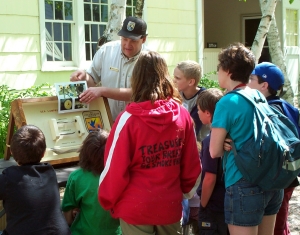 A man shows children sea lamprey educational materials